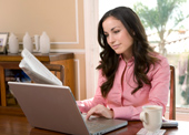 A woman is using a computer.