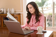 A woman is using a computer.